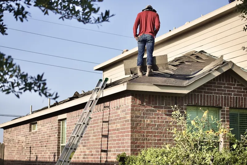 Professional roofer working on a residential roof in Centerville